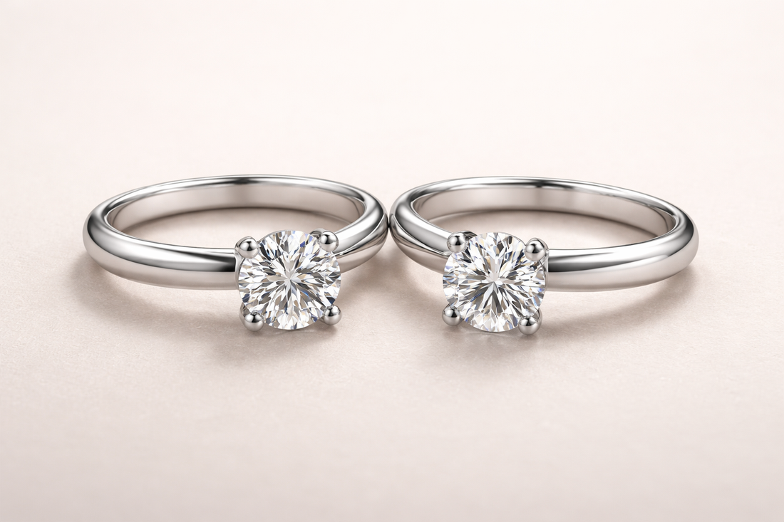 Close-up of two solitaire engagement rings with round diamonds on plain white-metal bands on a neutral background