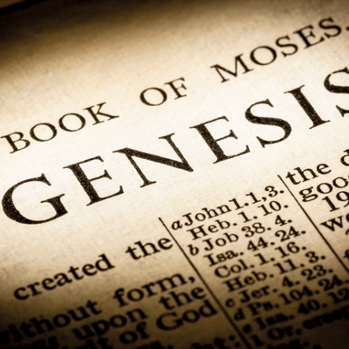 Close-up of the Book of Genesis page with the word “Genesis” in focus, representing the Old Testament scriptures.