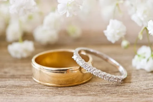 Ethically made wedding bands, his and her resting on top of each otherr 