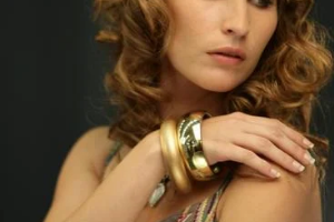 Photo of lady wearing gold maximalist bangles looking amazing 