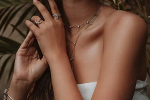Photo of a lady layering jewellery with elegance 