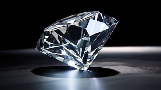 Close-up of a brilliant diamond on a black reflective surface, highlighting the gem’s cut and sparkle.