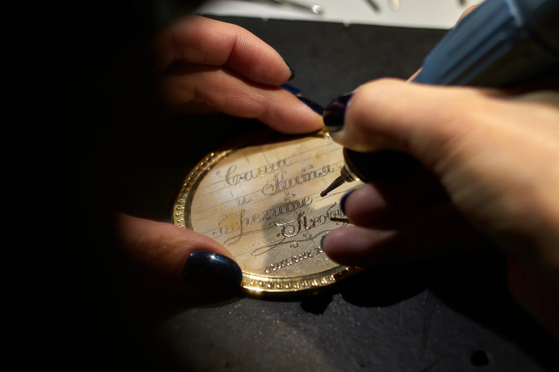 Lady engraving piece of jewellery with a memorable message 