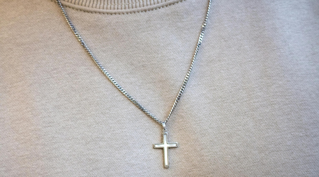 A man wearing a cross necklace