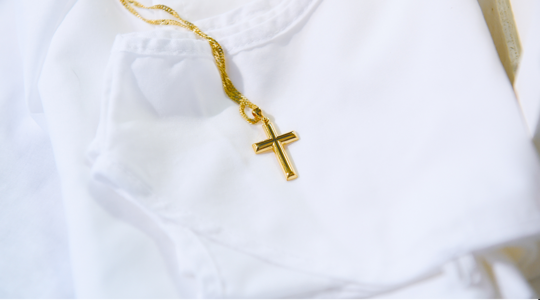 Gold cross on white T shirt