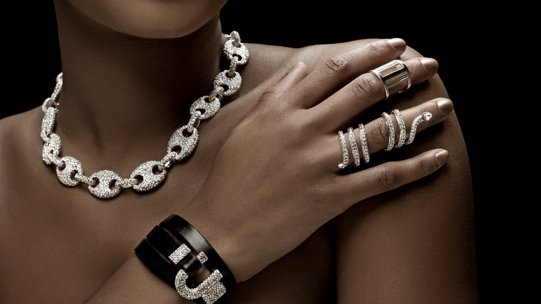 Layered necklaces and rings on woman's hand