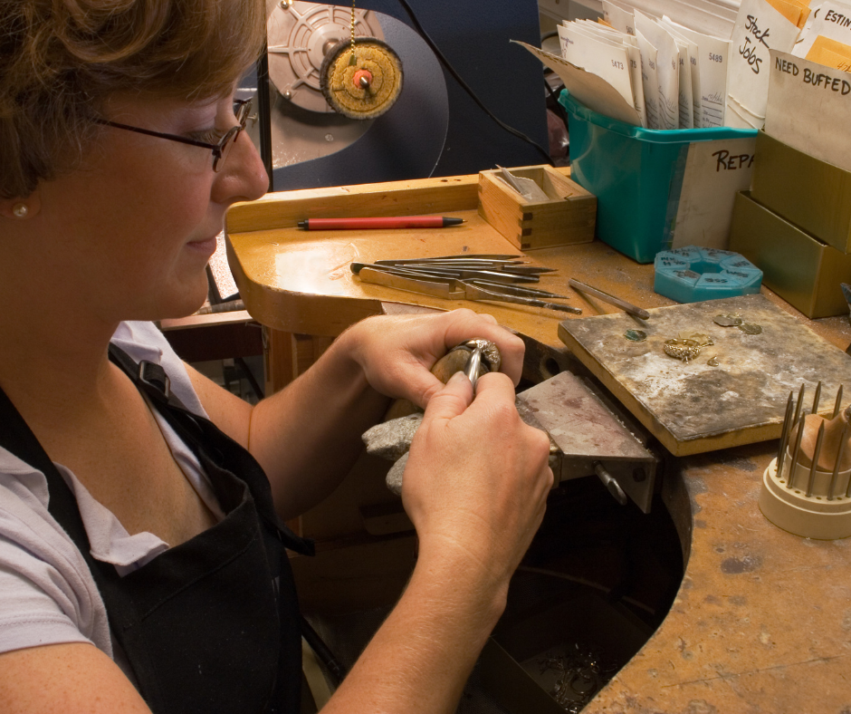 Female jeweller making a ring