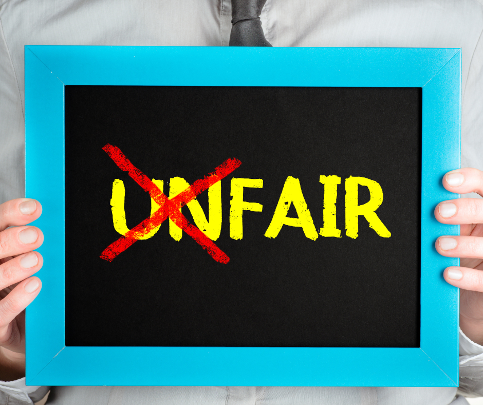 a lady holding a poster saying fairness