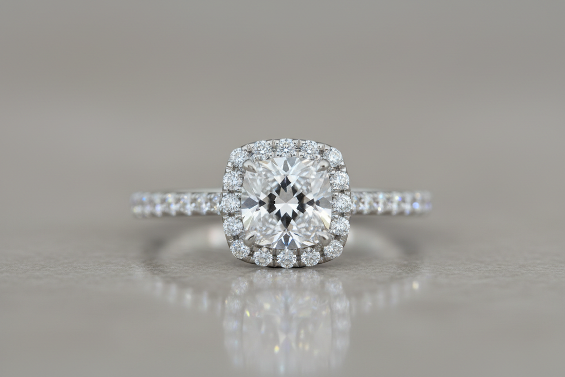 Close-up of a pavé-set diamond engagement ring under soft studio lighting