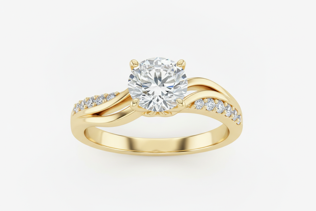 Close-up of a round diamond solitaire engagement ring on a yellow gold band with pavé diamonds along the band against a neutral background.
