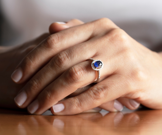 lady with hands crossed wear a sapphire ring