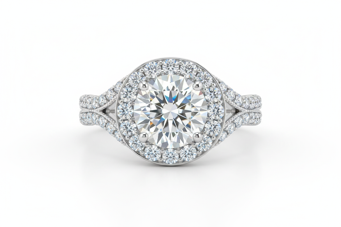 Close-up of a round diamond halo engagement ring on a white gold band with a split shank against a neutral background.