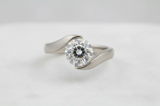 Close-up of a tension-set diamond engagement ring where the stone appears suspended between the ends of the band on a neutral background.
